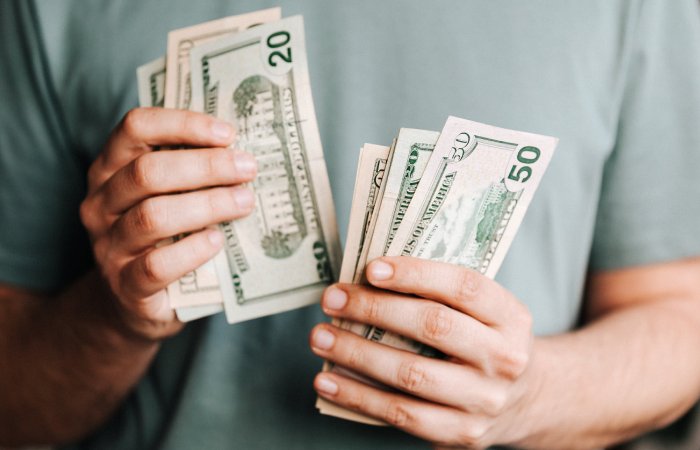Man counting $50 and $20 bills
